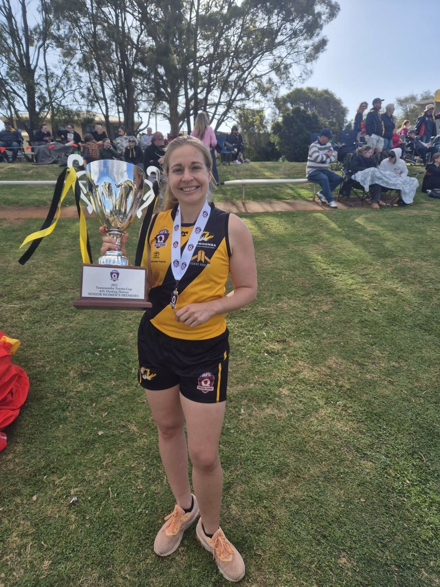 Lilly with the AFL Darling Downs premiership cup