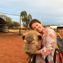 Emma hugging a camel in outback Australia