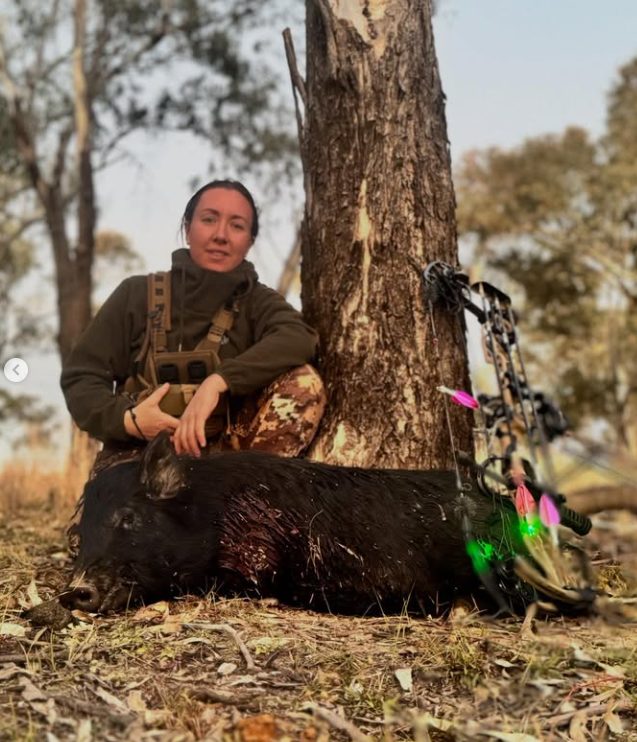 Nadine with her bow and a boar she took