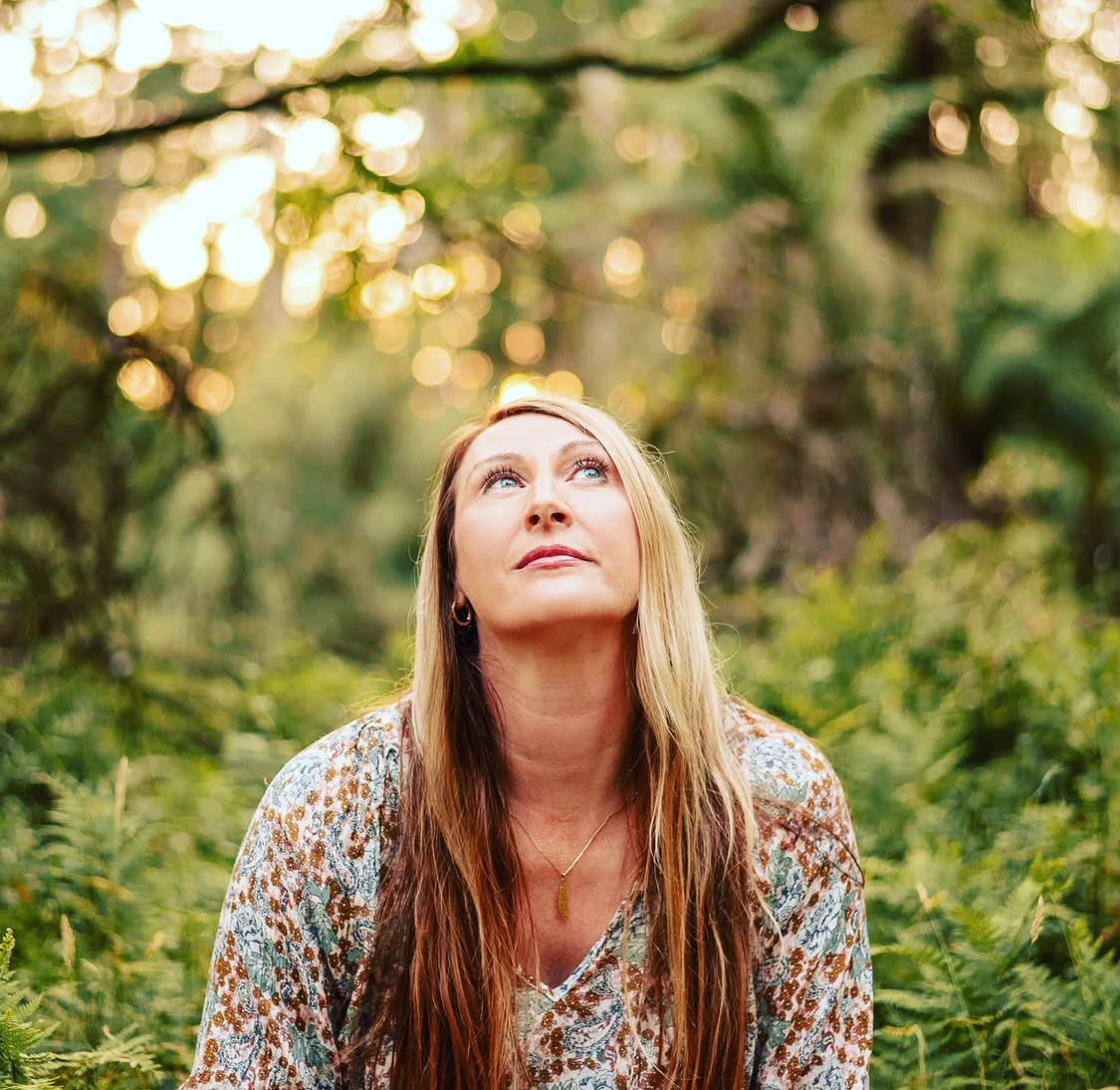 Farrah Buckland in the forest, looking upward